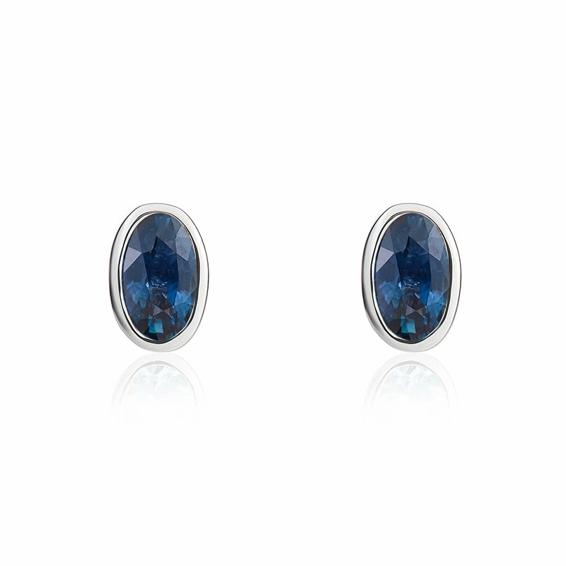 9ct White Gold Sapphire 5x3mm Oval Rub Over Set Stud Earrings